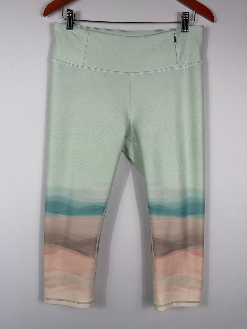 CALIA by Carrie Underwood Mint & Pastel Wave Cropped Leggings Size L. Small spot
